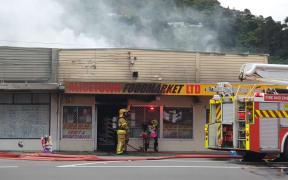 Firefighters outside the Alicetown Foodmarket, Lower Hutt, 18 April 2023.