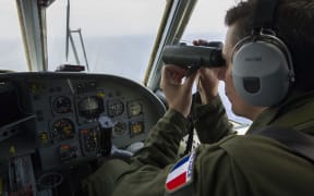 The French Navy (Marine Nationale) on May 22, 2016, shows a French soldier aboard an aircraft looking through binoculars during searches for debris from the crashed EgyptAir flight MS804 over the Mediterranean Sea.