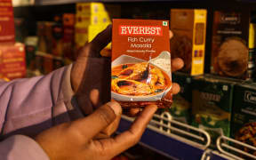 A shopkeeper holds a packet of Everest's Fish Curry Masala at a department store in Baramulla, Jammu and Kashmir, India, on 23 April, 2024.