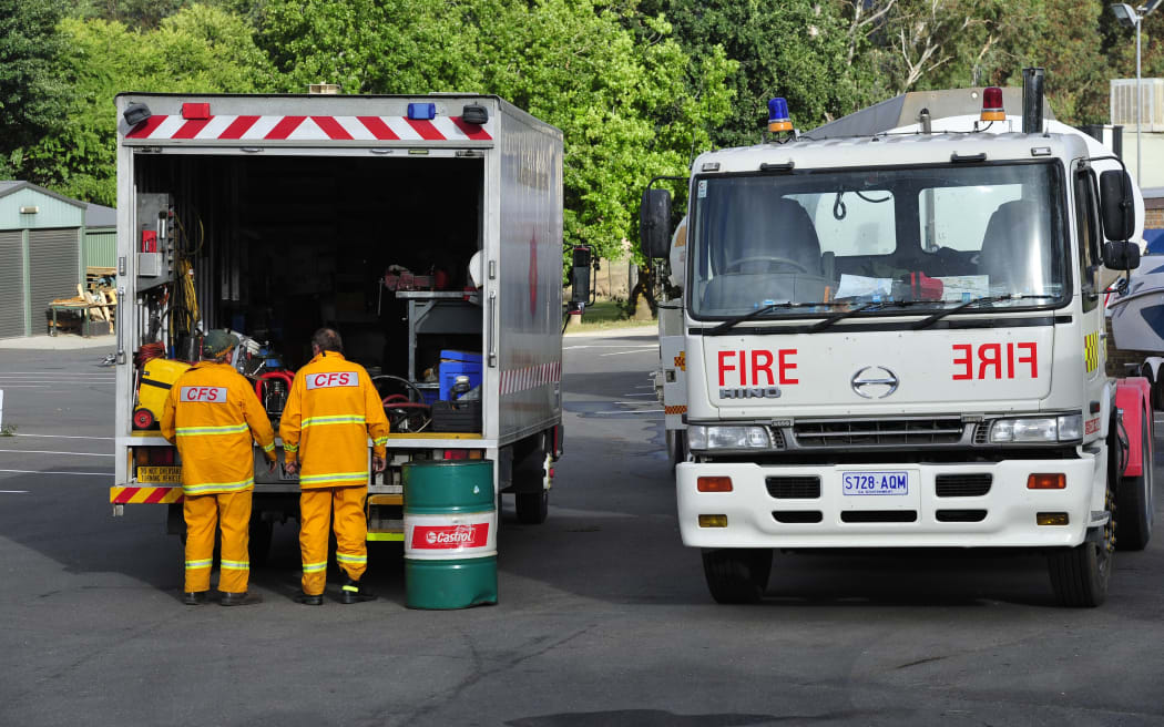 Fireman prepare their trucks in Gumeracha as fires burn through the Adelaide Hills on 4 January.