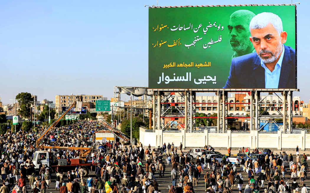 A billboard depicting Hamas' slain leader Yahya Sinwar with the Arabic slogan "if Sinwar departs from the battlefields, Palestine will birth a thousand Sinwars", during a rally in Yemen's Houthi-controlled capital Sanaa on October 18, 2024 in protest against Israel's attacks on Lebanon and the ongoing war between Israel and Hamas militants in the Gaza Strip. - Israel announced on October 17 the killing of Sinwar, mastermind of the October 7 attack, calling his death a "heavy blow" to the Palestinian group it has been fighting for more than a year. (Photo by Mohammed HUWAIS / AFP)