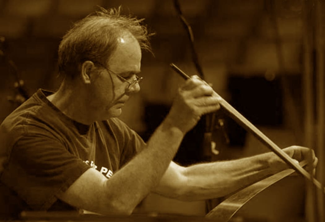 Dr John Egenes playing the musical saw