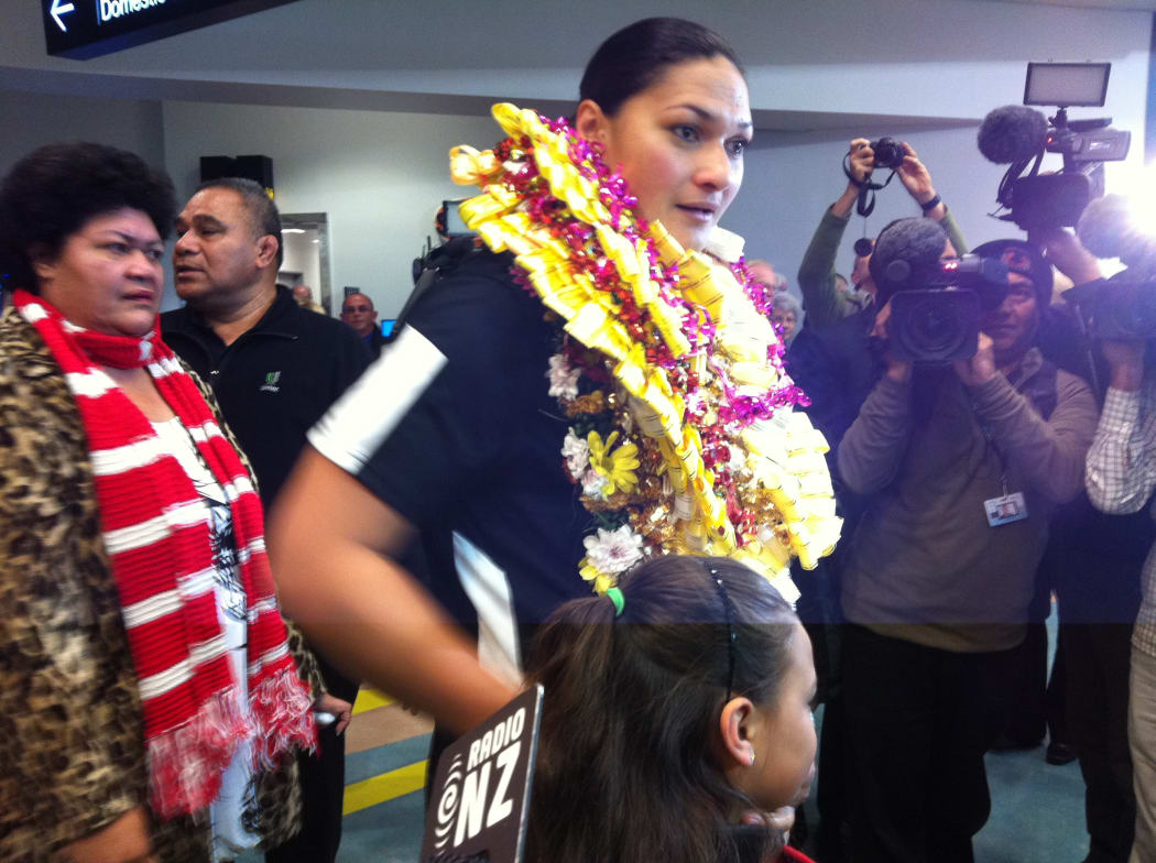 Valerie Adams was greeted by family and media at the airport.