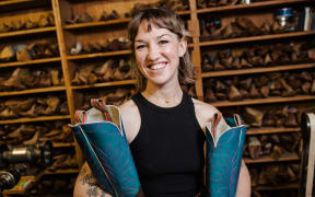 Flora holding a pair of Cowboy Boots