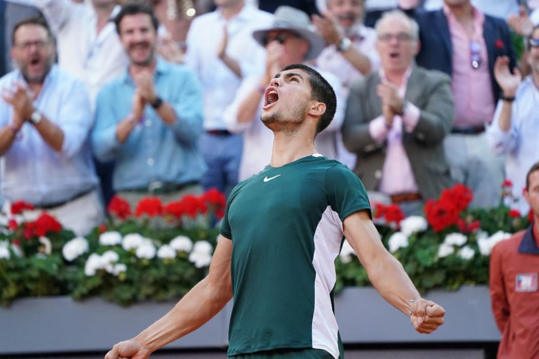 Carlos Alcaraz of Spain celebrates with the champion trophy after winning against Alexander Zverev of Germany during the Final ATP match during the Mutua Madrid Open 2022 celebrated at La Caja Magica