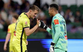 Scott Wootton and Josh Oluwayemi of the Phoenix celebrate after winning the A-League Men Round 2 match between Perth Glory and Wellington Phoenix.