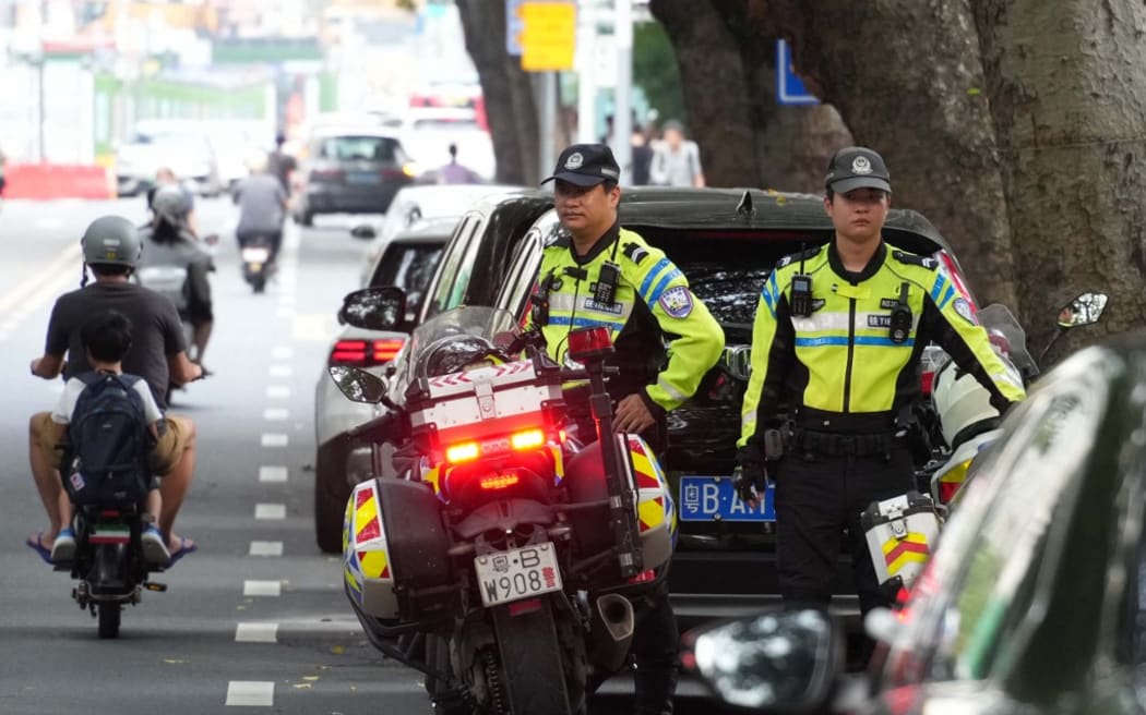 Police officers are on the lookout around a Japanese school in Shenzhen, Guangdong, China, on September 20, 2024. A Chinese man stabbed a 10-year-old Japanese boy on his way to his school on the 18th, and the boy unfortunately lost his life the following day. ( The Yomiuri Shimbun ) (Photo by Ichiro OHARA / Yomiuri / The Yomiuri Shimbun via AFP)
