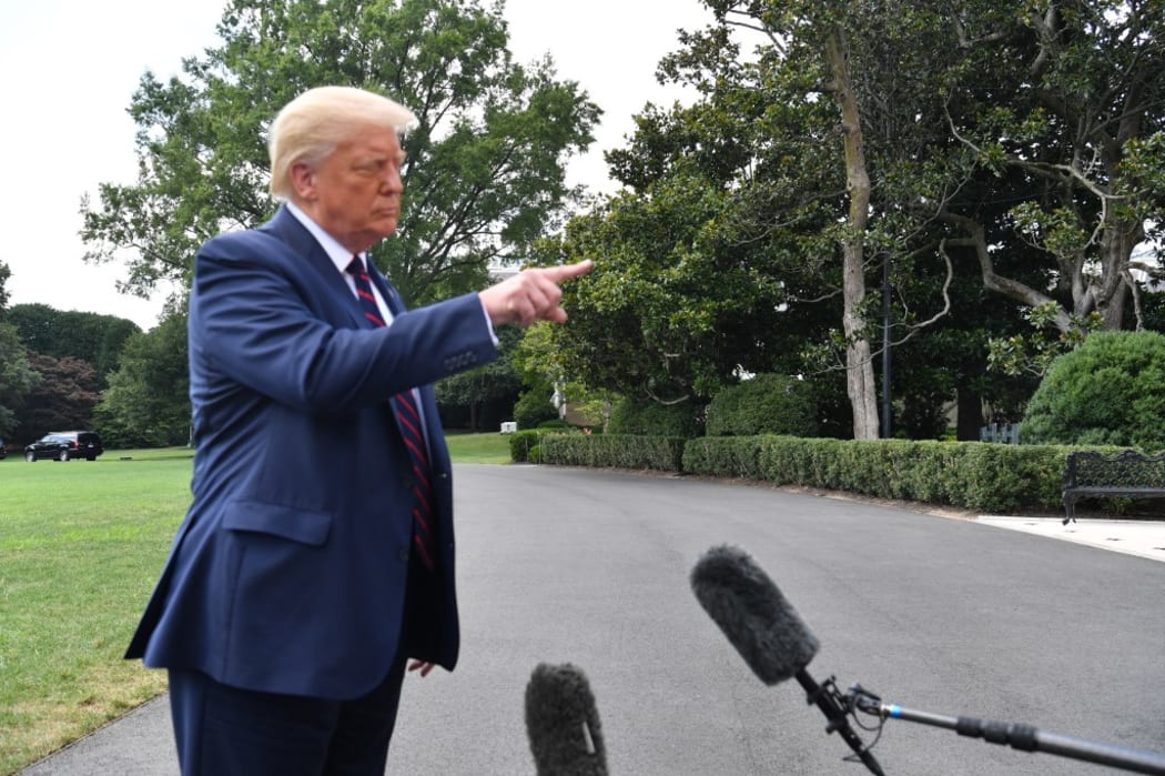 US President Donald Trump speaks to the press before departing from the White House in Washington,DC.