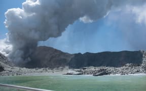 This handout photograph courtesy of Michael Schade shows the volcano on New Zealand's White Island spewing steam and ash minutes following an eruption on December 9, 2019.