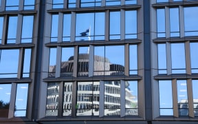 The Beehive reflected in a Ministry building