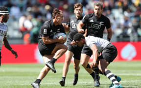 New Zealand's Joe Webber takes on the Fiji defence in the Cup Semi Final in Cape Town.