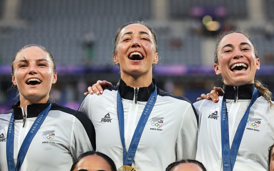 Michaela Blyde, Sarah Hirini and Jazmin Felix-Hotham of New Zealand celebrate winning the gold medal.