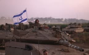 A convoy of Israeli armoured vehicles advances near the border with Gaza on October 12, 2023. Thousands of people, both Israeli and Palestinian, have died since October 7, after Palestinian Hamas militants entered Israel in a surprise attack leading Israel to declare war on Hamas in the Gaza Strip enclave. (Photo by Menahem KAHANA / AFP)