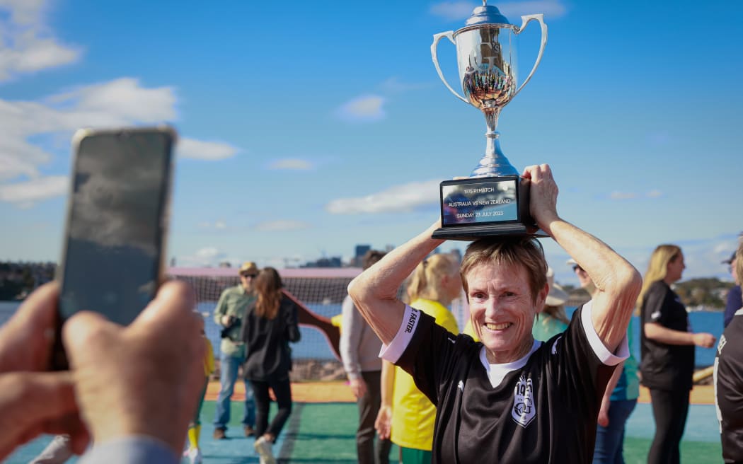 Carol Knox poses for a photo with the trophy before the 1975 OG Australia v New Zealand Rematch on PUMA Island July 22, 2023 in Sydney, Australia.