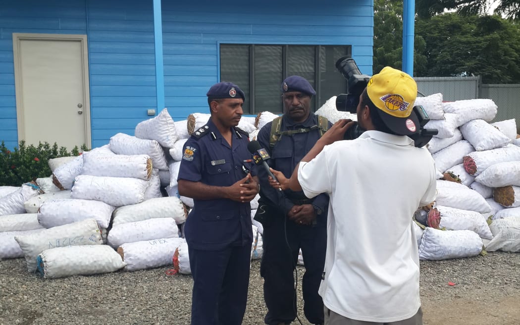 NCD Police Commander, Andy Bawa, and the Superintendent Operations pose for media in front of the confiscated betel nut

Papua New Guinea.