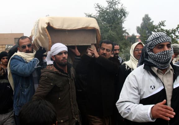 The coffin of a man killed in fighting is being carried for burial in Fallujah.