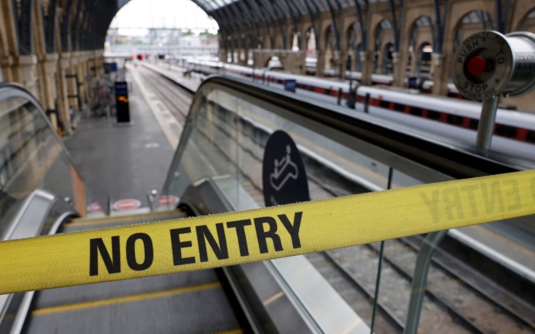 A "No Entry" belt barrier blocks access to a platform at King's Cross railway station in London on July 27, 2022 as fresh railway strikes hit the country. - Around 40,000 British railway workers staged a walkout, a month after the largest strike in 30 years as the UK battles its worst cost-of-living crisis in decades. (Photo by CARLOS JASSO / AFP)