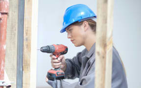 Woman working on construction site.
