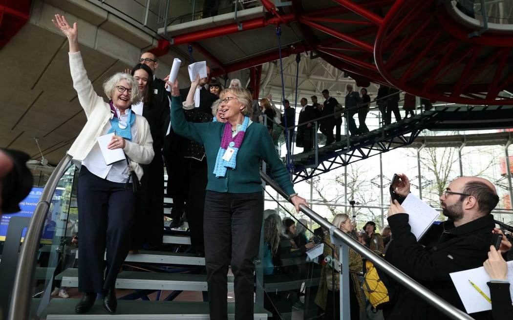 Members of Swiss association Senior Women for Climate Protection react after the announcement of decisions after a hearing of the European Court of Human Rights (ECHR) to decide in three separate cases if states are doing enough in the face of global warming in rulings that could force them to do more, in Strasbourg, eastern France, on April 9, 2024. Europe's top rights court on April 9 said Switzerland was not doing enough to tackle climate change, in the first such ruling on the responsibility of states in curbing global warming. The ECHR however threw out two other cases against European states on procedural grounds. (Photo by Frederick FLORIN / AFP)