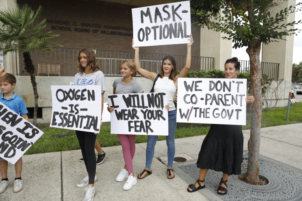 Families protest before a Hillsborough County Schools Board meeting about masks in Tampa, Florida.
