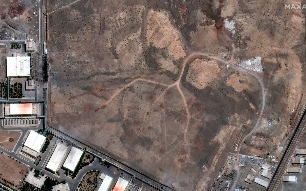 This handout satellite image released by Maxar Technologies on June 15, 2025, shows new vehicle tracks and dirt piles over underground centrifuge buildings at Natanz enrichment facility, southeast of Tehran after airstrikes on June 15, 2025. The Israeli military said early June 16 that it was striking surface-to-surface missile sites in Iran, its latest move in three days of escalating conflict between the rival states. "The IDF is currently striking surface-to-surface missile sites in central Iran," Israel Defense Forces (IDF) spokesman Nadav Shoshani wrote on X. "We are operating against this threat in our skies and in Iranian skies." (Photo by Handout / Satellite image ©2025 Maxar Technologies / AFP) / RESTRICTED TO EDITORIAL USE - MANDATORY CREDIT "AFP PHOTO / MAXAR TECHNOLOGIES " - NO MARKETING NO ADVERTISING CAMPAIGNS - DISTRIBUTED AS A SERVICE TO CLIENTS - EXISTING WATERMARKS MAY NOT BE REMOVED/CROPPED / “The erroneous source appearing in the metadata of this handout photo has been modified in AFP...