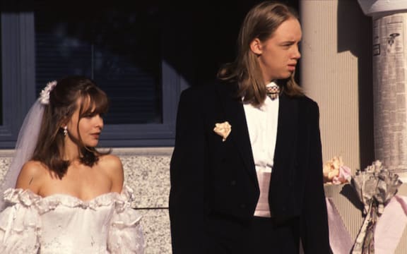 Rachel McKenna and Nick Harrison on their wedding day. Rachel is in a white wedding dress. Nick wears a tuxedo.