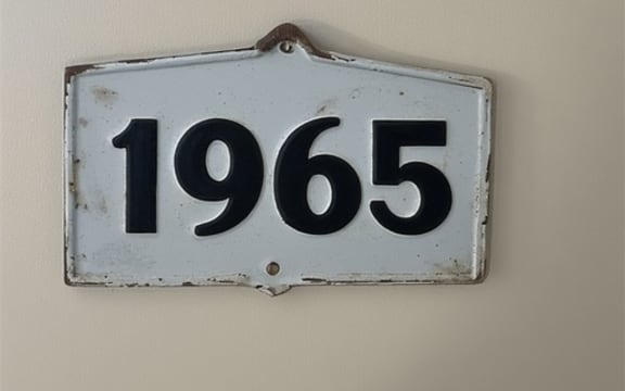 The number 1965 on a wall sign