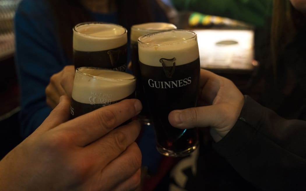 Young people toasting inside a pub with half pints of Guinness black beer, the most popular in Dublin (Ireland). (Photo by Joaquin Gomez Sastre/NurPhoto) (Photo by Joaquin Gomez Sastre / NurPhoto / NurPhoto via AFP)