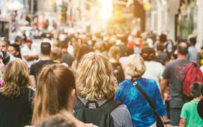 Unrecognizable mass of people walking in the city