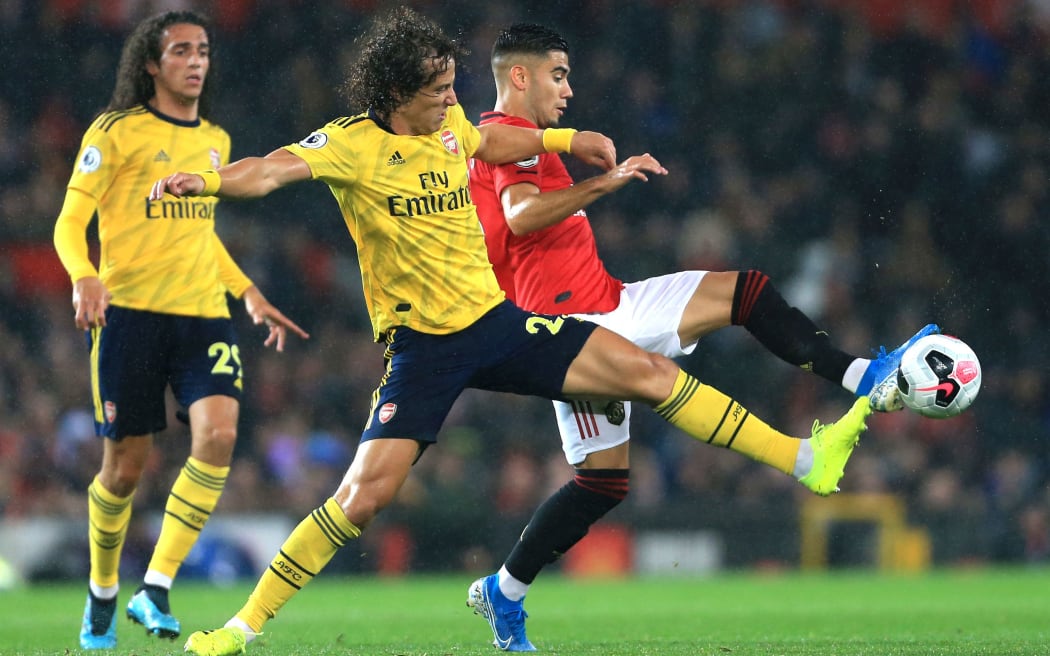 David Luiz of Arsenal challenges Andreas Pereira of Manchester United for the ball.