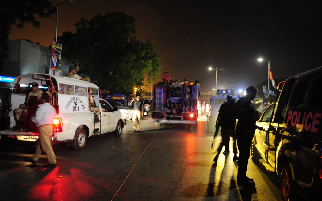 Pakistani security personnel gather outside the Jinnah International Airport after the militants' assault in Karachi.