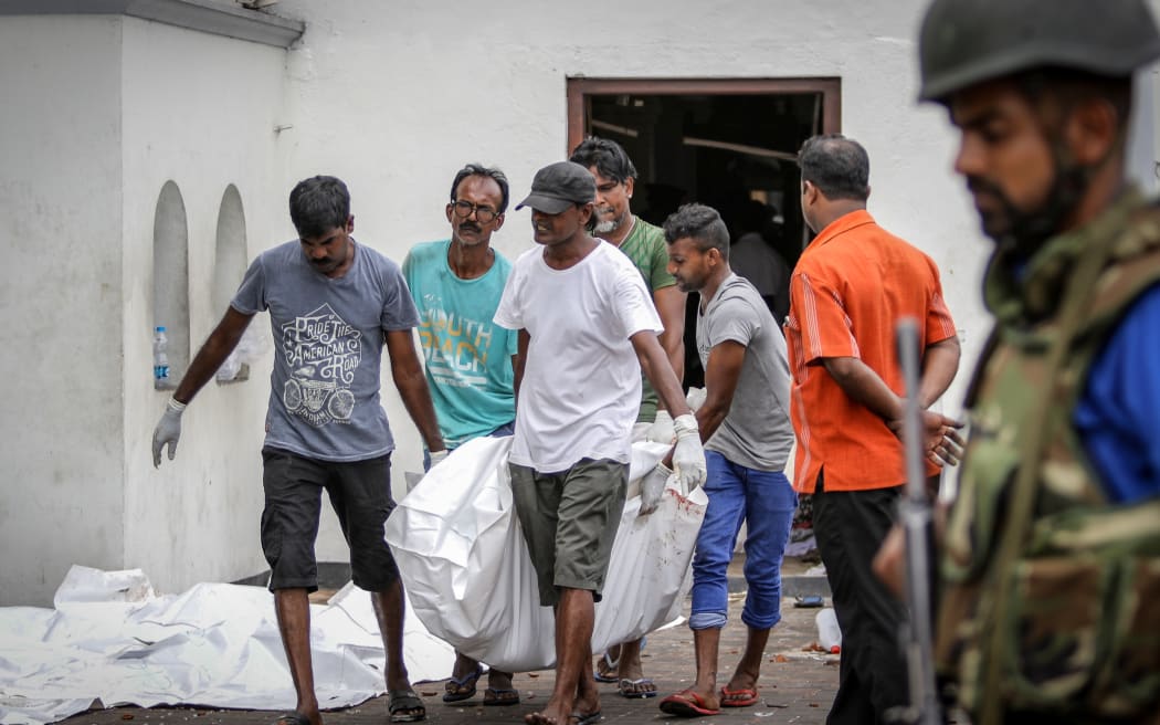 Dead Bodies are carried away for identification in front of the St Anthony's Church.