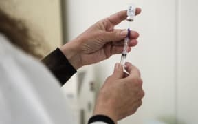 A medical worker fills a syringe with a dose of the Pfizer-BioNTech Covid-19 vaccine as the country launches its inoculation campaign at the University Clinic for Infectious Diseases in Skopje on February 17, 2021.