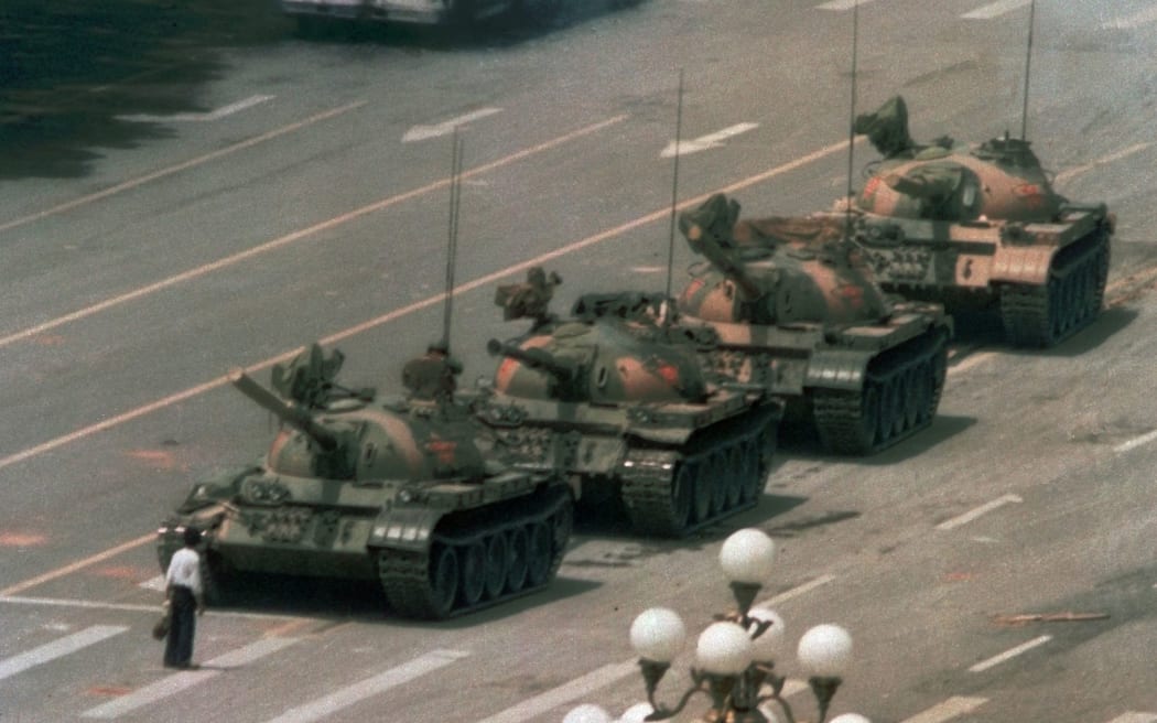 FILE - In this June 5, 1989, file photo, a Chinese man stands alone to block a line of tanks heading east on Beijing's Changan Blvd. in Tiananmen Square
