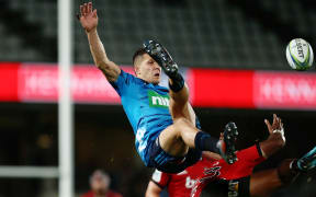 Matt Duffie of the Blues clashes in the air with Manasa Mataele of the Crusaders.