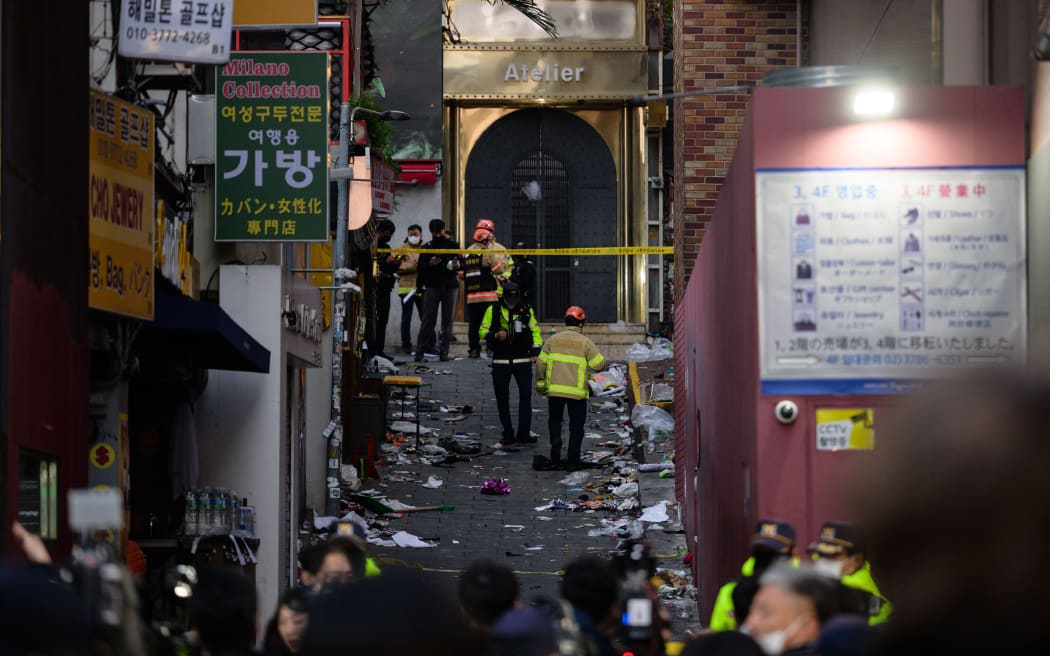 Emergency service personnel are seen in the alley where a Halloween stampede took place late 29 October, in the neighbourhood of Itaewon in Seoul on October 30, 2022.