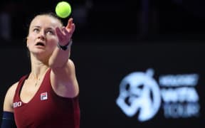 Czech Republic's Barbora Krejcikova serves against US' Coco Gauff during their women's singles tennis match at the WTA Finals Championship in Riyadh, November 2024.