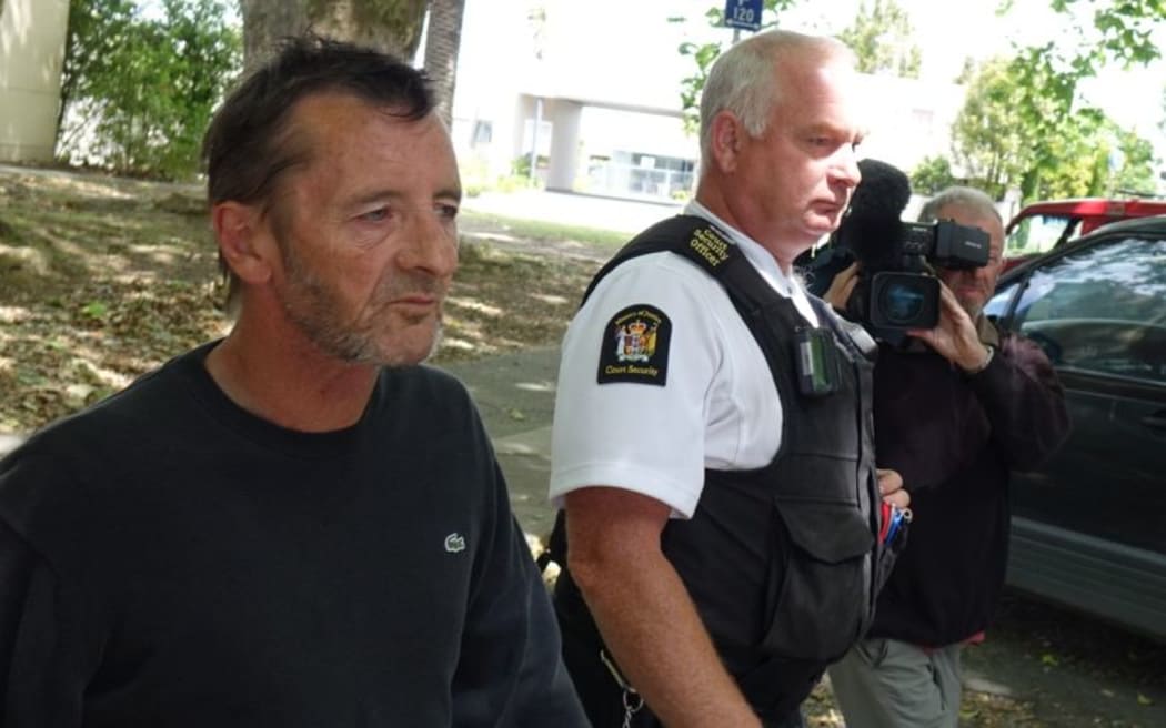 Phil Rudd leaves the court after breaching his bail conditions by being in the same shop as a witness.
