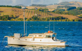 Fishing boat and landscape near Mangonui, Northland Region, New Zealand