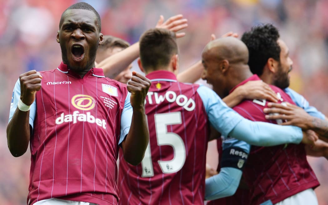 Aston Villa's Zaire-born Belgian striker Christian Benteke (L) celebrates Villa's second goal during the FA Cup semi-final between Aston Villa and Liverpool at Wembley stadium in London on April 19, 2015.