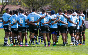 The Fijian Drua huddle together.