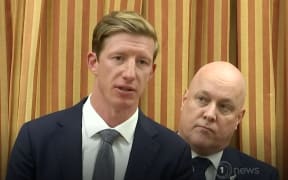 MP Sam Uffindell speaks to media with his leader Christopher Luxon looks on.