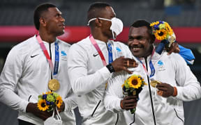 Fiji players celebrate with their gold medals while standing on the podium after the victory ceremony following the men's final rugby sevens match during the Tokyo 2020 Olympic Games at the Tokyo Stadium in Tokyo on July 28, 2021.