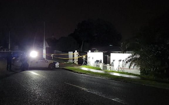 Police outside a house in in Henderson, West Auckland, where a woman was killed in a shooting.