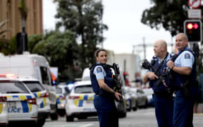 Armed police remain at the scene of a serious shooting incident in downtown Auckland on 20 July, 2023.