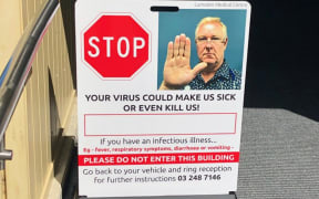 Virus warning sign at a medical centre.