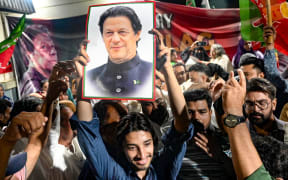 Supporters of Pakistan's jailed former Prime Minister Imran Khan hold his poster as they celebrate after he was aquitted of leaking state secrets following a court verdict in Karachi on June 3, 2024. A Pakistan high court on June 3, overturned a treason conviction against jailed former prime minister Imran Khan, months after his party was sidelined in a general election. (Photo by Rizwan TABASSUM / AFP)
