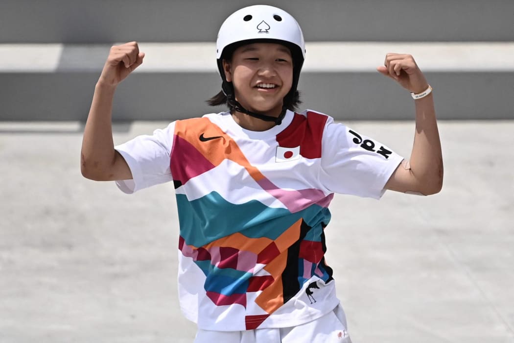 Japan's Momiji Nishiya celebrates after performing a trick during the skateboarding women's street final of the Tokyo 2020 Olympic Games at Ariake Sports Park in Tokyo on July 26, 2021.