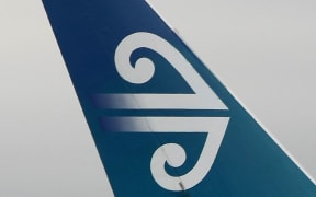 Air New Zealand logo on tail fin of plane.