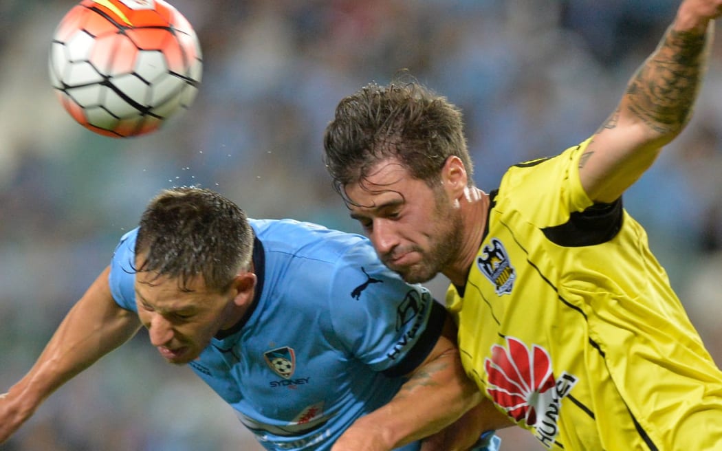 Phoenix player Tom Doyle (right) battles for the ball.